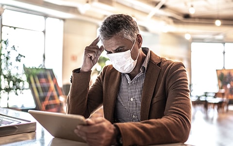 man sitting with mask on