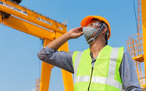 man wearing a mask at a construction site