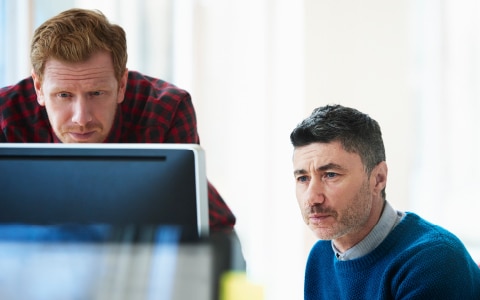 Two males looking at a computer screen