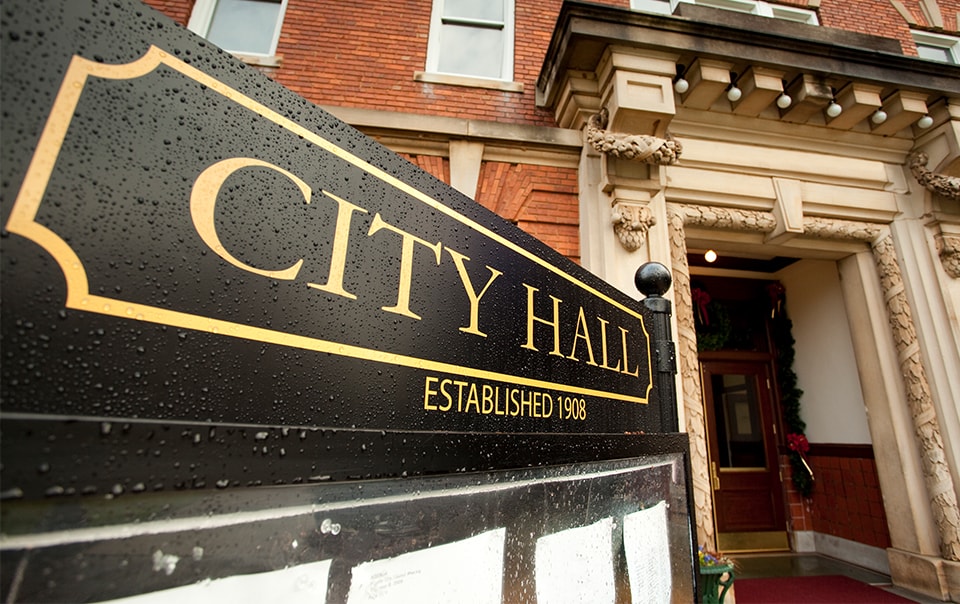 sign outside of building that has city hall on it, Risk Control Considerations for Public Entities During and After the COVID-19 Pandemic